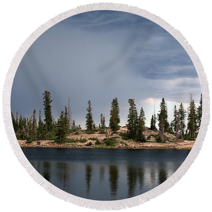Landscape Round Beach Towel featuring the photograph Shoreline Pine Trees and Storm by Brett Pelletier