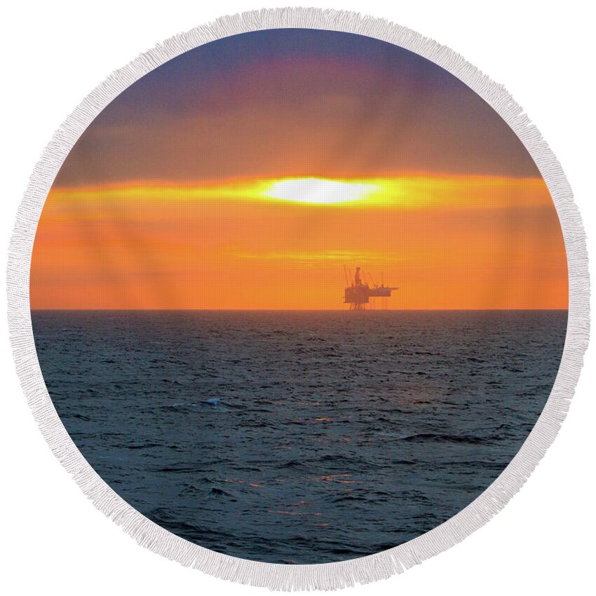 North Atlantic Round Beach Towel featuring the photograph Silhouetted oil drilling platform by Allan Levin