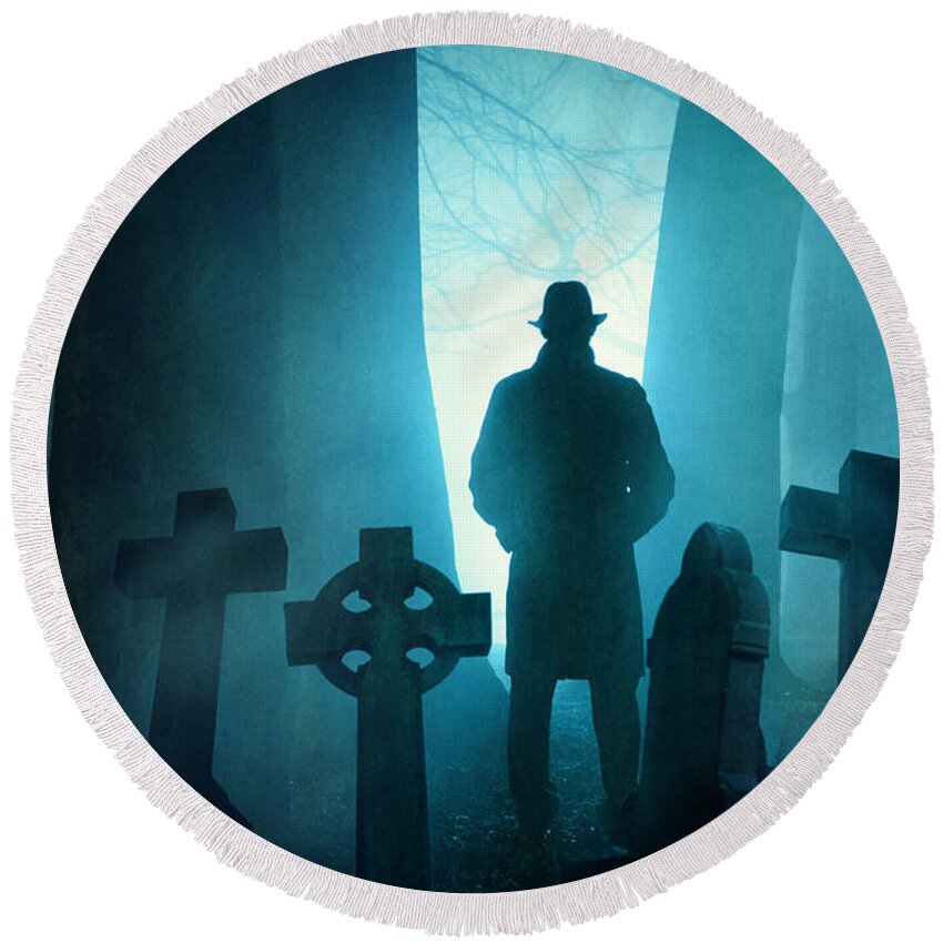 Graveyard Round Beach Towel featuring the photograph Sinister Man In Silhouette In A Foggy Graveyard At Night by Lee Avison