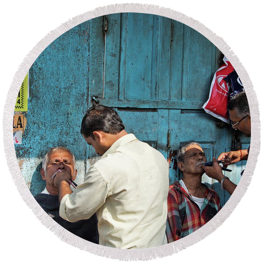 Street Side Barbershop In The Back Streets Of Mumbai. Round Beach Towel featuring the photograph Snip and tuck by Marion Galt