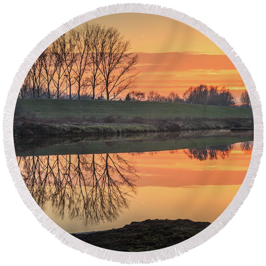 Reflection Round Beach Towel featuring the photograph Trees reflection in the water at sunset in Meinerswijk by Tim Abeln
