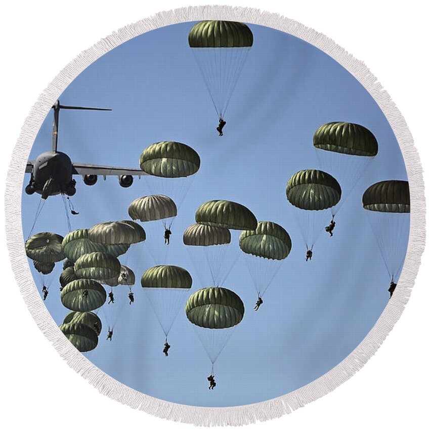 Parachutist Round Beach Towel featuring the photograph U.s. Army Paratroopers Jumping by Stocktrek Images