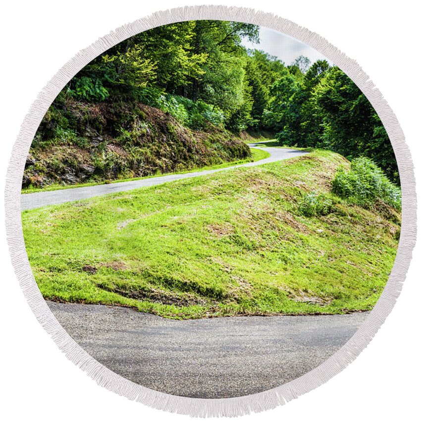 Boussenac Round Beach Towel featuring the photograph Winding road with sharp bend going up the mountain by Semmick Photo