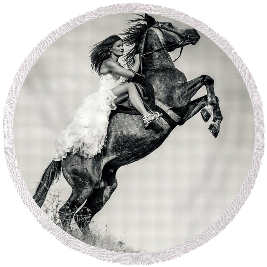 Horse Round Beach Towel featuring the photograph Woman in dress riding chestnut black rearing stallion by Dimitar Hristov