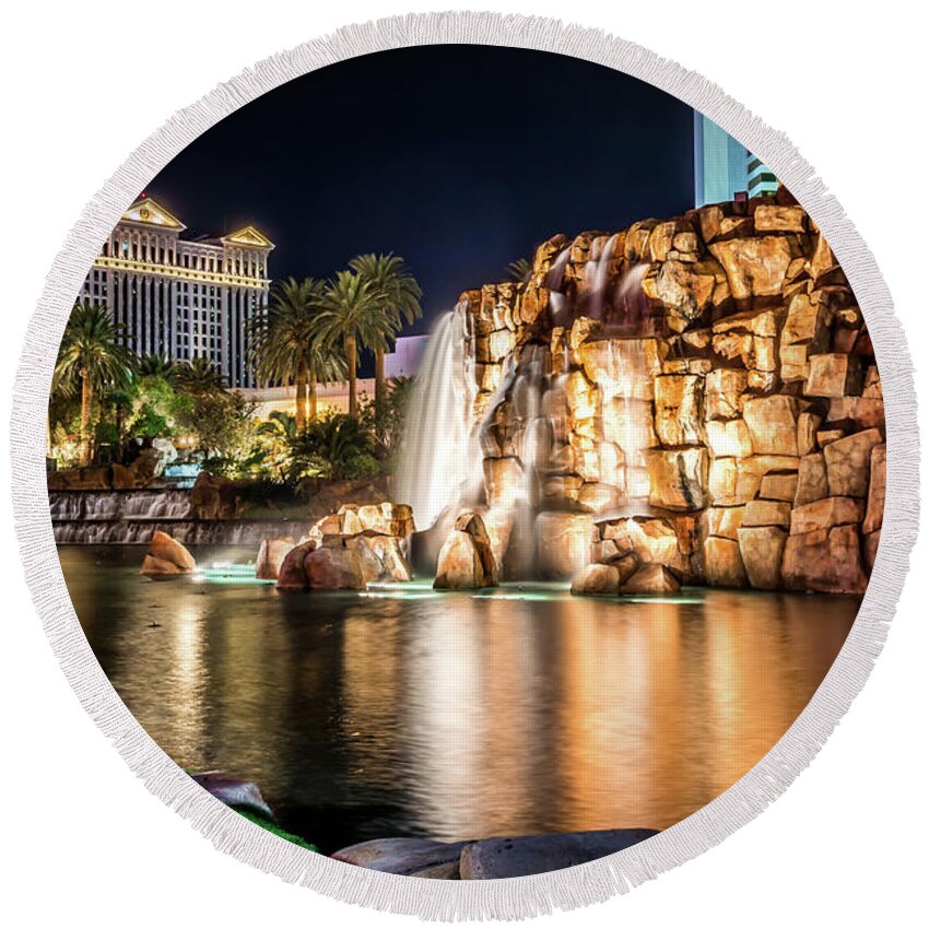 Vegas Round Beach Towel featuring the photograph Mirage Hotel Casino Volcano Fountain At Night #1 by Alex Grichenko
