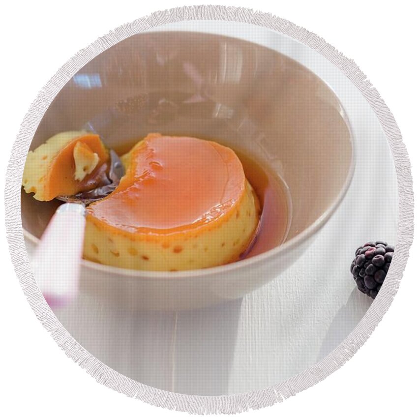 Ip_11311937 Round Beach Towel featuring the photograph A Bowl Of Creme Caramel With A Bite Taken Out by Au Petit Gout Photography Llc