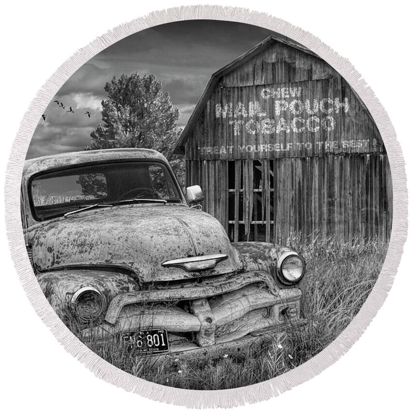 Chevy Round Beach Towel featuring the photograph Black and White of Rusted Chevy Pickup Truck in a Rural Landscape by a Mail Pouch Tobacco Barn by Randall Nyhof