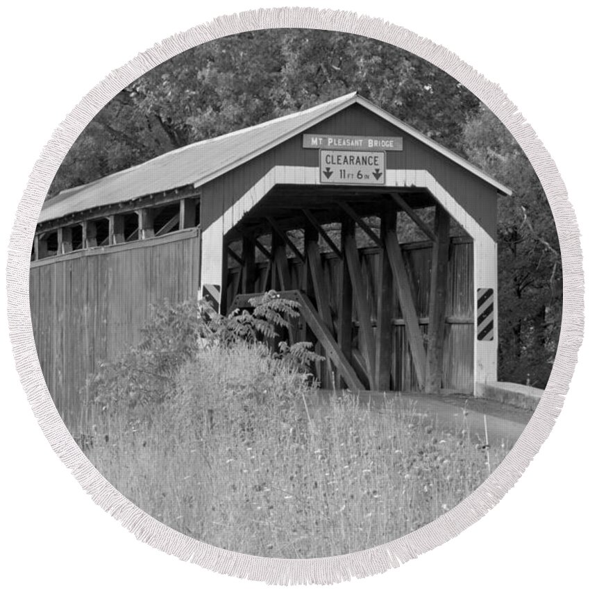 Mt Pleasant Covered Bridge Round Beach Towel featuring the photograph Mt. Pleasant Covere Bridge Through The Grass Black And White by Adam Jewell