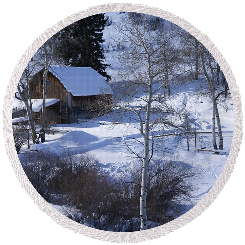 Snow Round Beach Towel featuring the photograph Old western barn in snow with aspens by Steve Estvanik