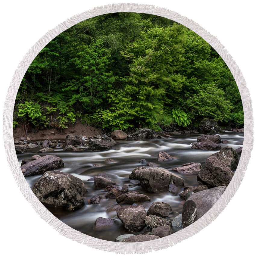Background Round Beach Towel featuring the photograph Wild Mountain River Streaming Through Green Forest in Scotland by Andreas Berthold