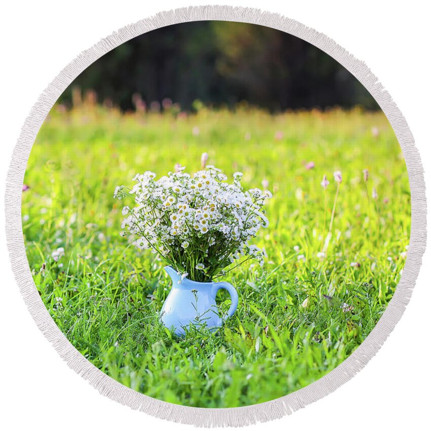 Flower Round Beach Towel featuring the photograph Bouquet of small white daisy flowers in a blue ceramic vase #1 by Olga Strogonova