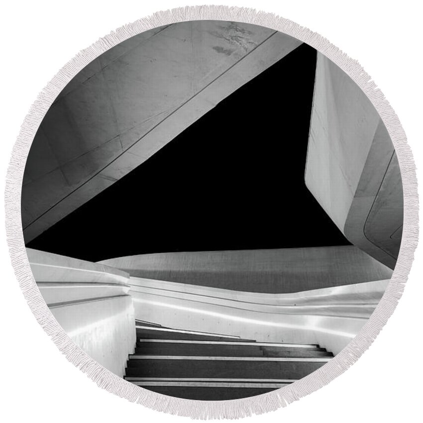 Futuristic Building Round Beach Towel featuring the photograph Modern architecture and empty staircase leading to a bright open space. by Michalakis Ppalis