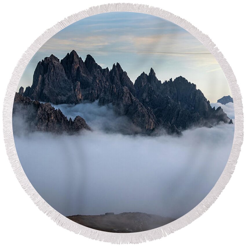 Dolomites Round Beach Towel featuring the photograph Mountain peaks above the clouds by Michalakis Ppalis