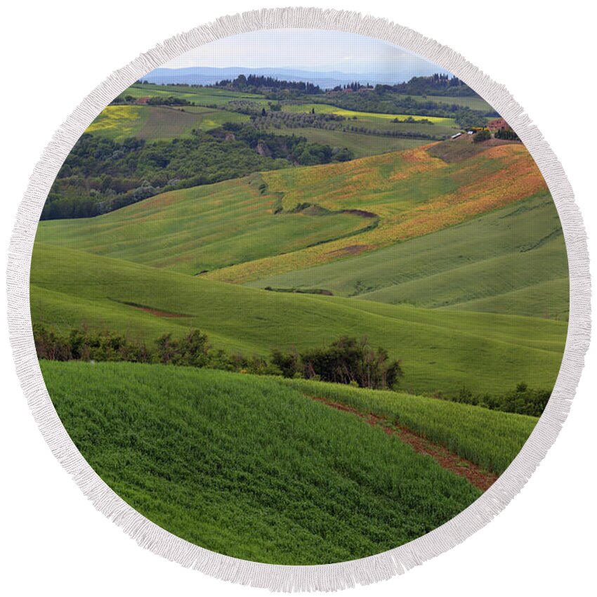 Field Round Beach Towel featuring the photograph Tuscany farmland hill fields in Italy #1 by Mikhail Kokhanchikov