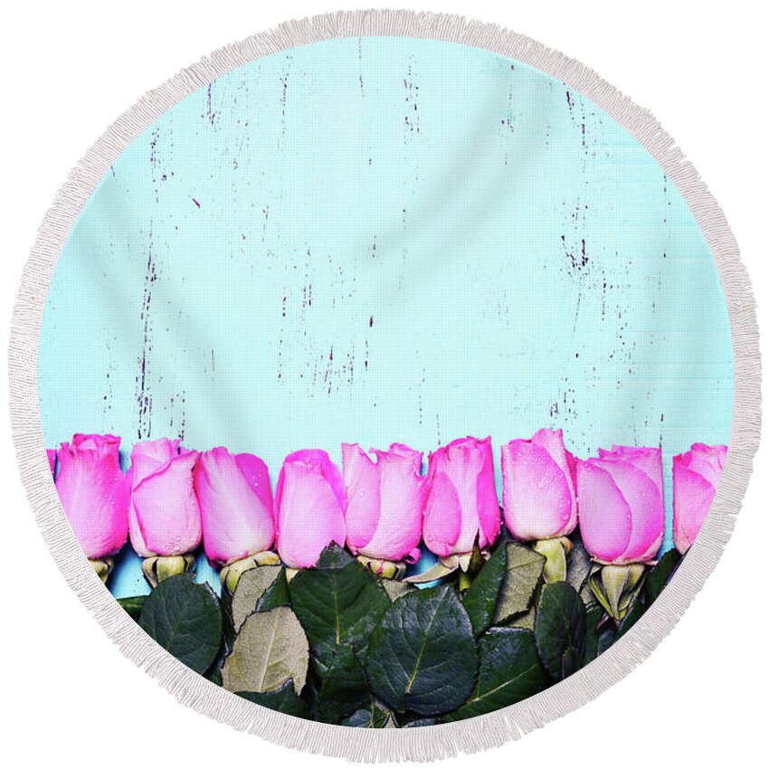Anniversary Round Beach Towel featuring the photograph Vintage aqua blue wood background with pink rose buds. #1 by Milleflore Images
