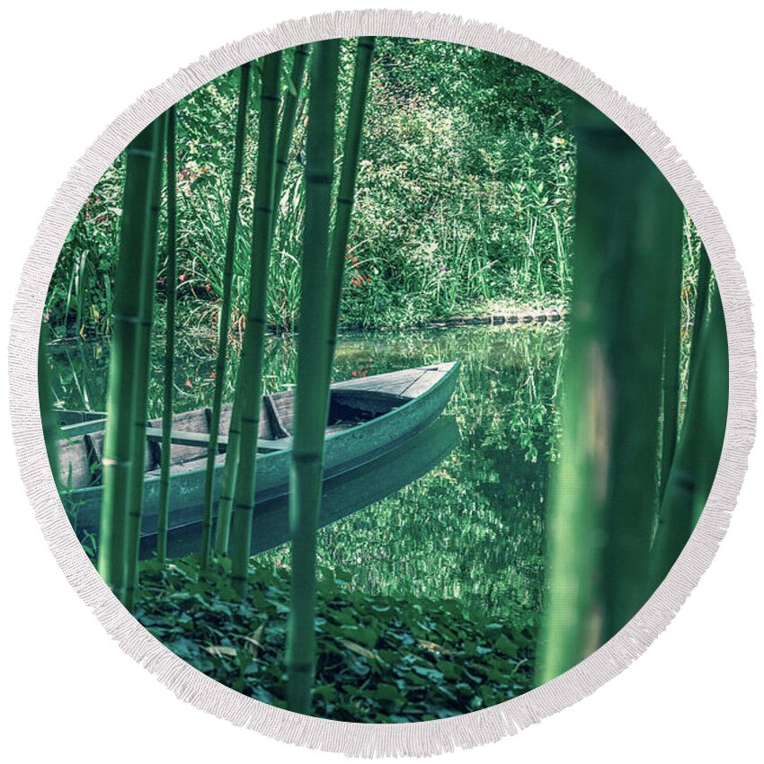 Environmental Conservation Round Beach Towel featuring the photograph Bamboo forest and Rowboat on a small pond by Benoit Bruchez