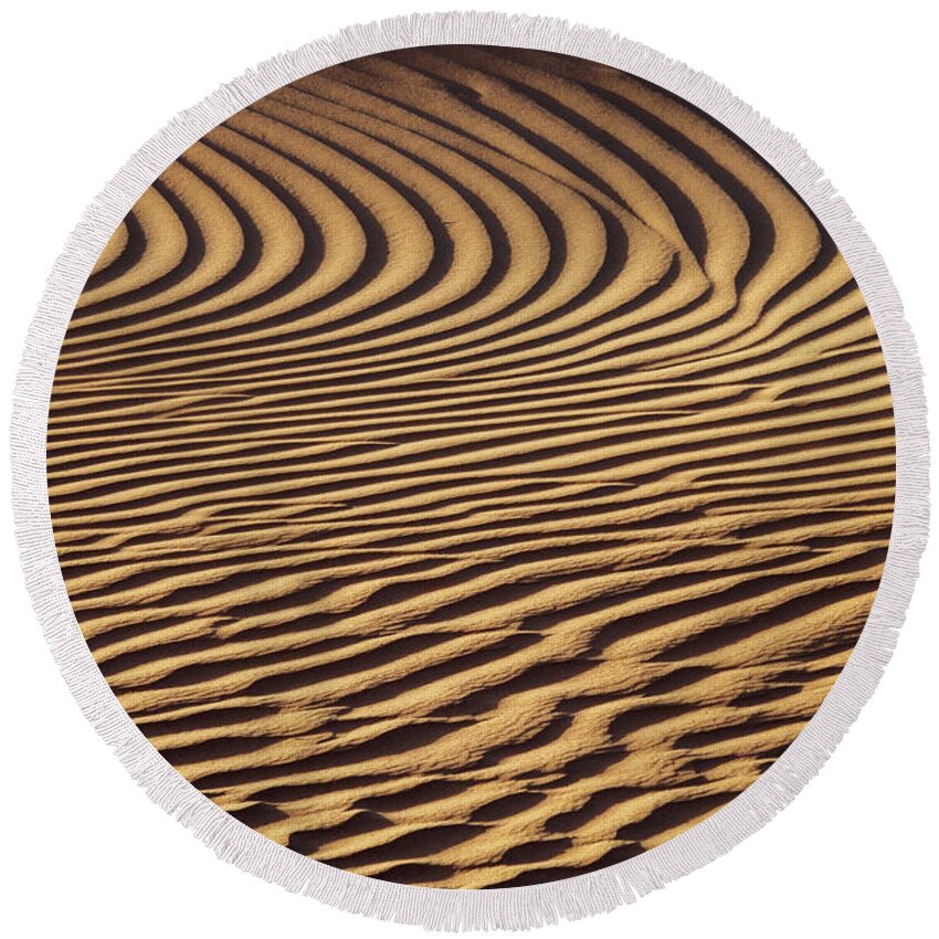 Sand Round Beach Towel featuring the photograph Beautiful sand dune pattern in wind by Mikhail Kokhanchikov