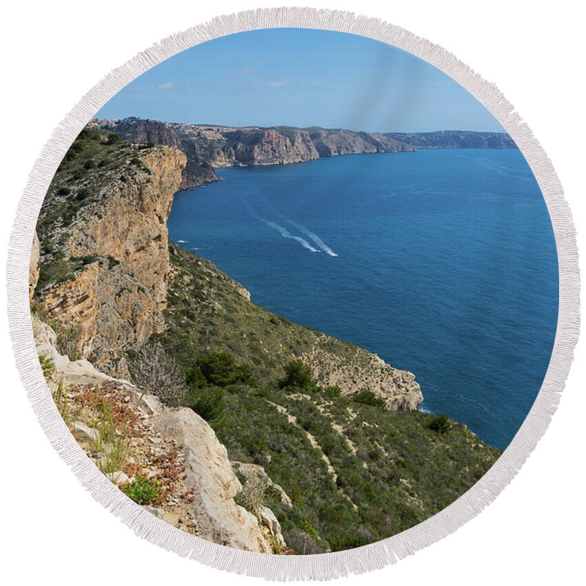 Mediterranean Sea Round Beach Towel featuring the photograph Blue Mediterranean Sea and limestone cliffs by Adriana Mueller