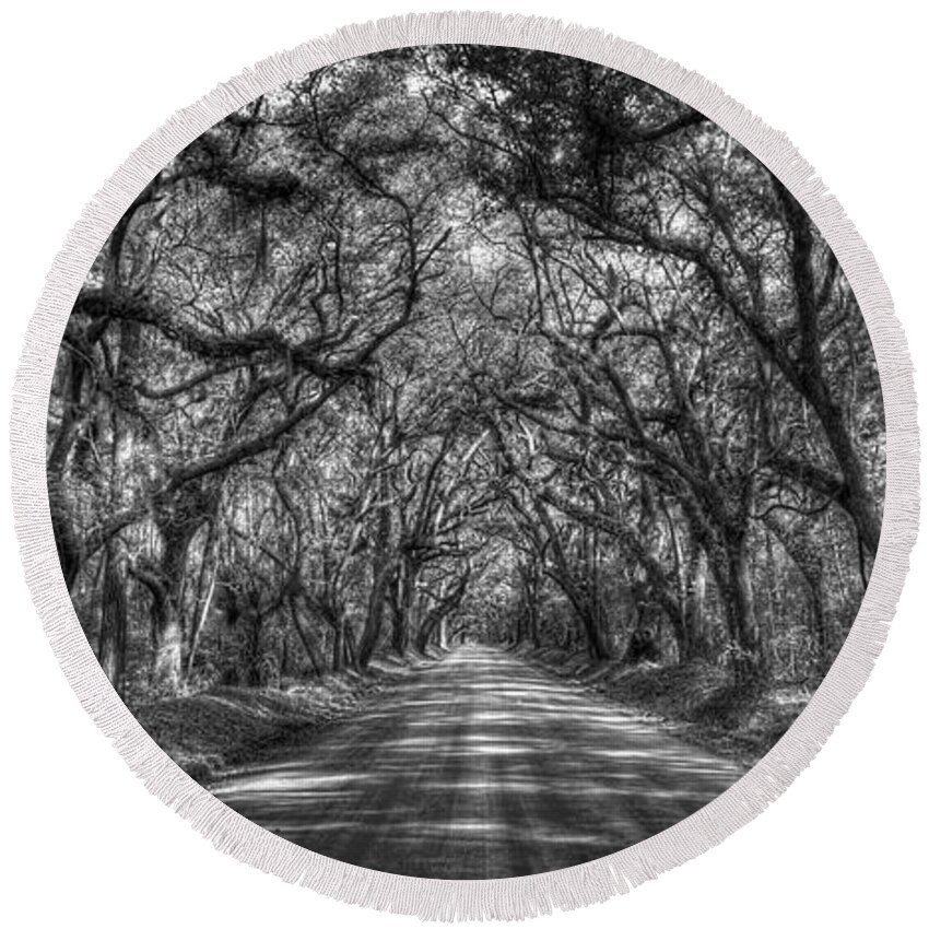 Reid Callaway The Majestic. Tree Tunnel Round Beach Towel featuring the photograph Charleston SC The Majestic Tree Tunnel Panorama B W Edisto Island Botany Bay Road Landscape Art by Reid Callaway