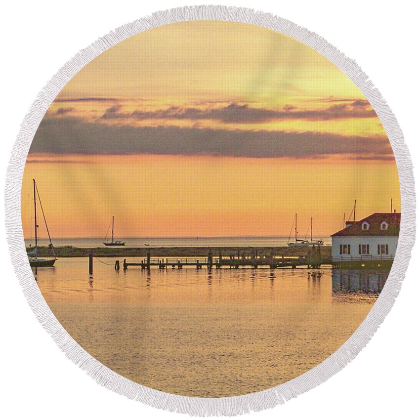 A Sailboat Gets An Early Start On A Summer Morning In Cuttyhunk Harbor. Gosnold Massachusetts Buzzards Bay Cape Cod Morning Sunrise Life Saving Station Uscg Round Beach Towel featuring the photograph Day Begins by Nautical Chartworks