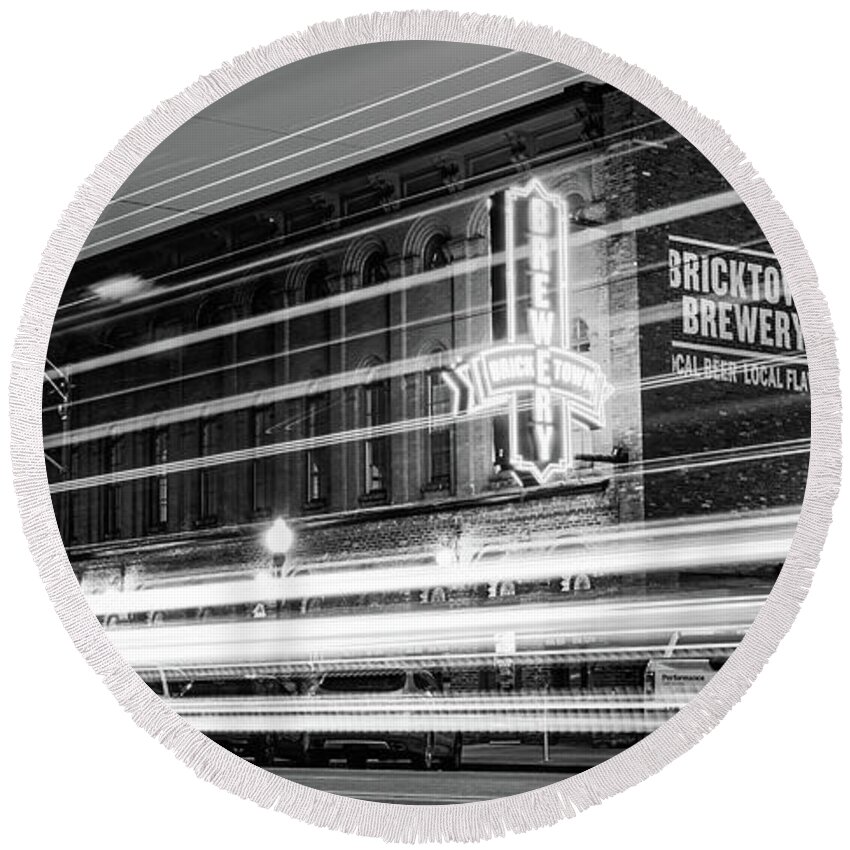 Fort Smith Round Beach Towel featuring the photograph Fort Smith Light Trails And Brewery Neon - Monochrome Panorama by Gregory Ballos