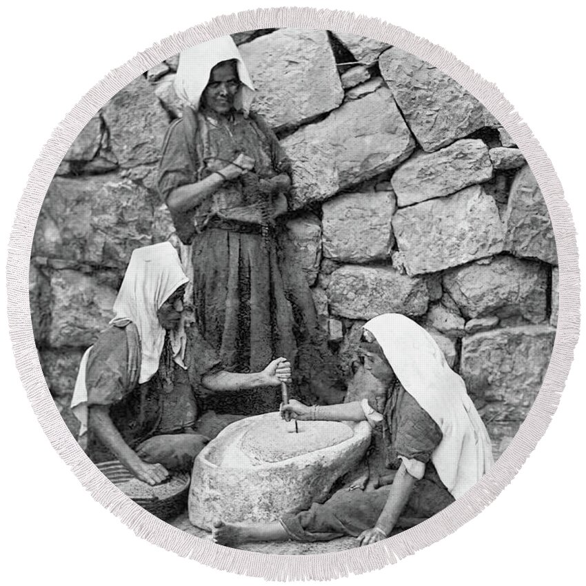 Women Round Beach Towel featuring the photograph Grinding in Bethlehem in 1917 by Munir Alawi