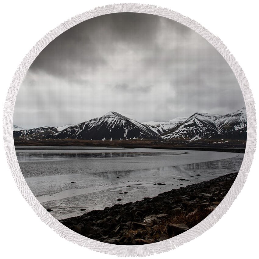 Iceland Round Beach Towel featuring the photograph Icelandic landscape with frozen lake and mountains covered in snow by Michalakis Ppalis