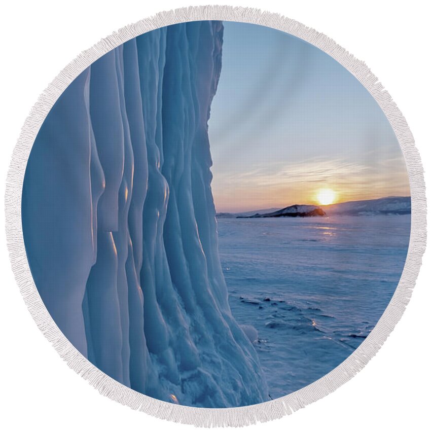 Icicle Round Beach Towel featuring the photograph Icicles on rocks on Lake Baikal by Mikhail Kokhanchikov
