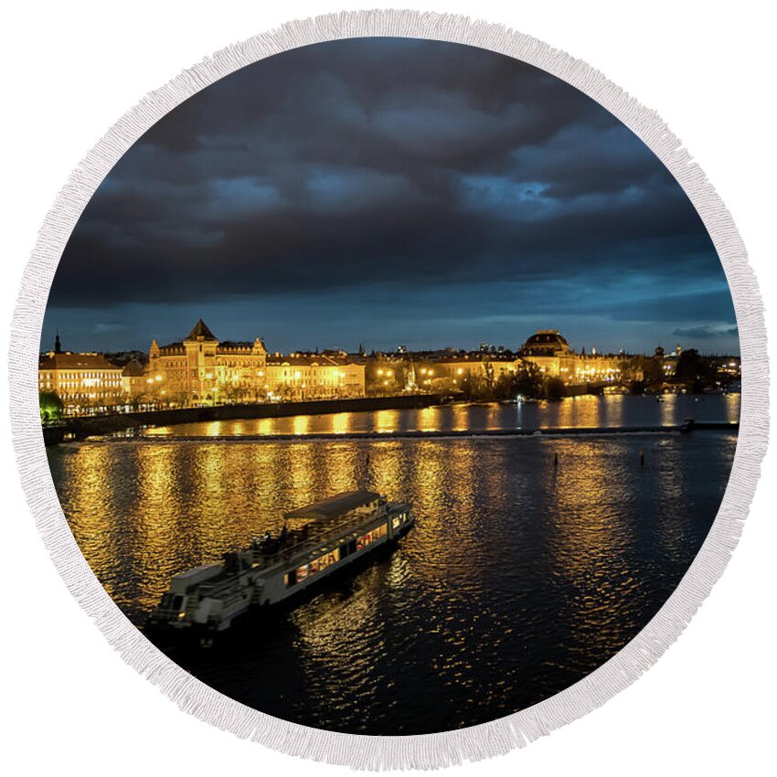 Architecture Round Beach Towel featuring the photograph Illuminated Moldova River With Ship And Buildings In The Night In Prague In The Czech Republic by Andreas Berthold