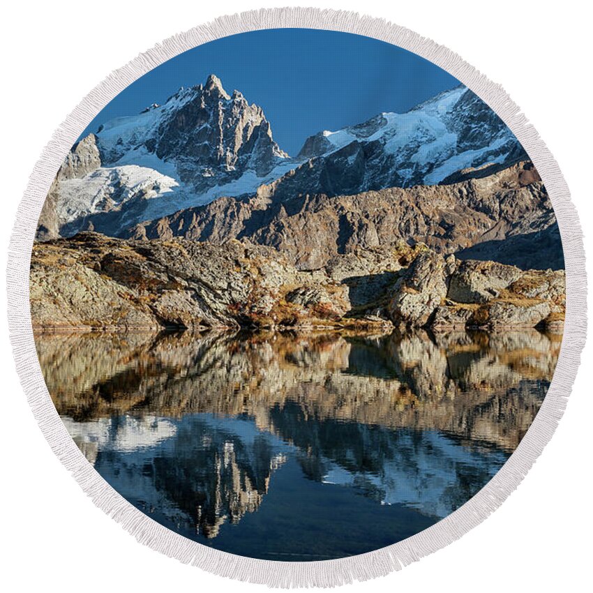Lake Round Beach Towel featuring the photograph La Meije peak mirrored in Lake Lerie by Olivier Parent