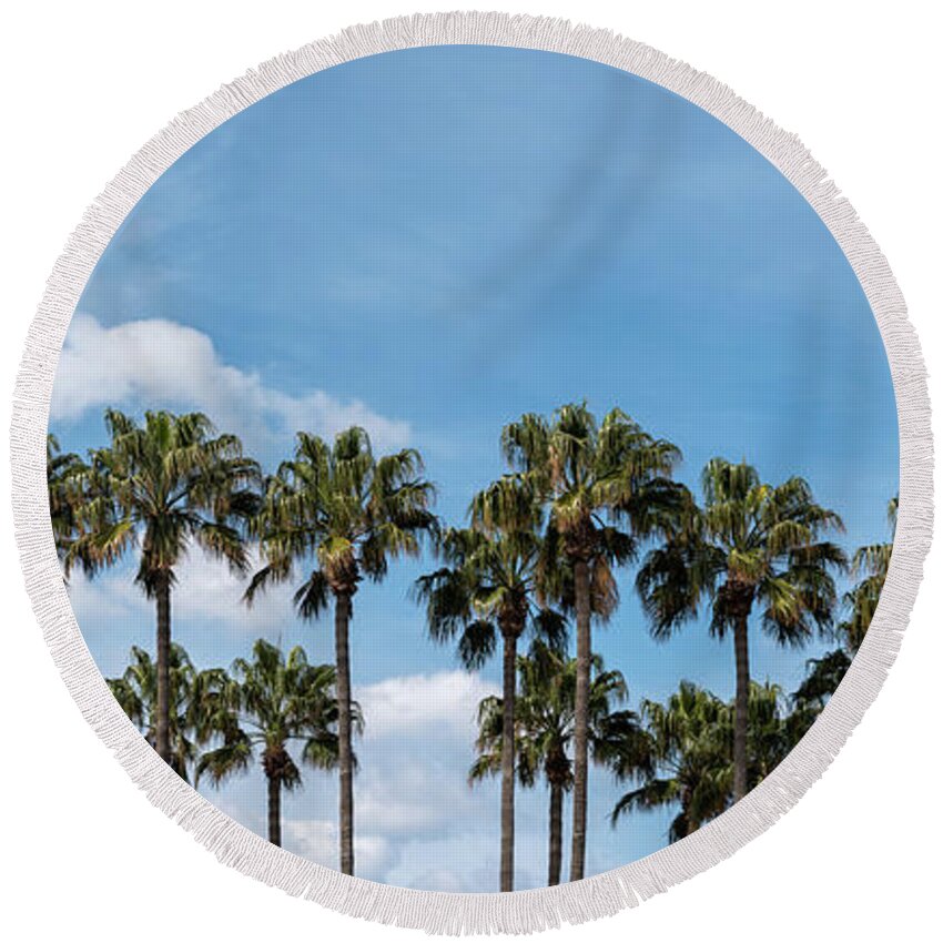 Palm Tree Round Beach Towel featuring the photograph Palm trees against blue sky, at tropical coast by Michalakis Ppalis