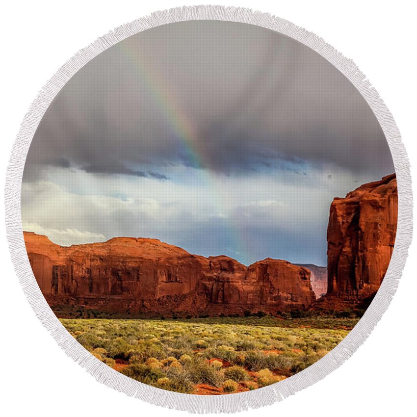Monument Valley Round Beach Towel featuring the photograph rainbow in Monument valley by Alberto Zanoni