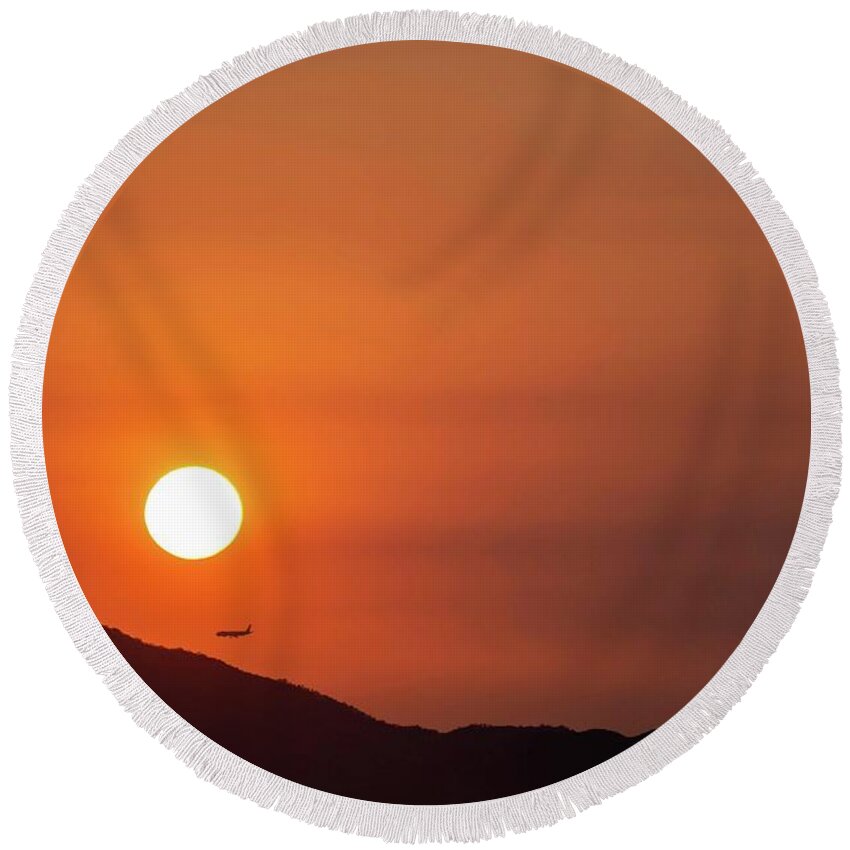 Sunset Round Beach Towel featuring the photograph Red sunset and plane in flight by Hannes Roeckel