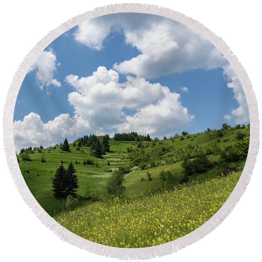 Big Sky Round Beach Towel featuring the photograph Rhodope Mountain Village Layers - Wildflower Meadows Green Hillsides and Fab Clouds by Georgia Mizuleva