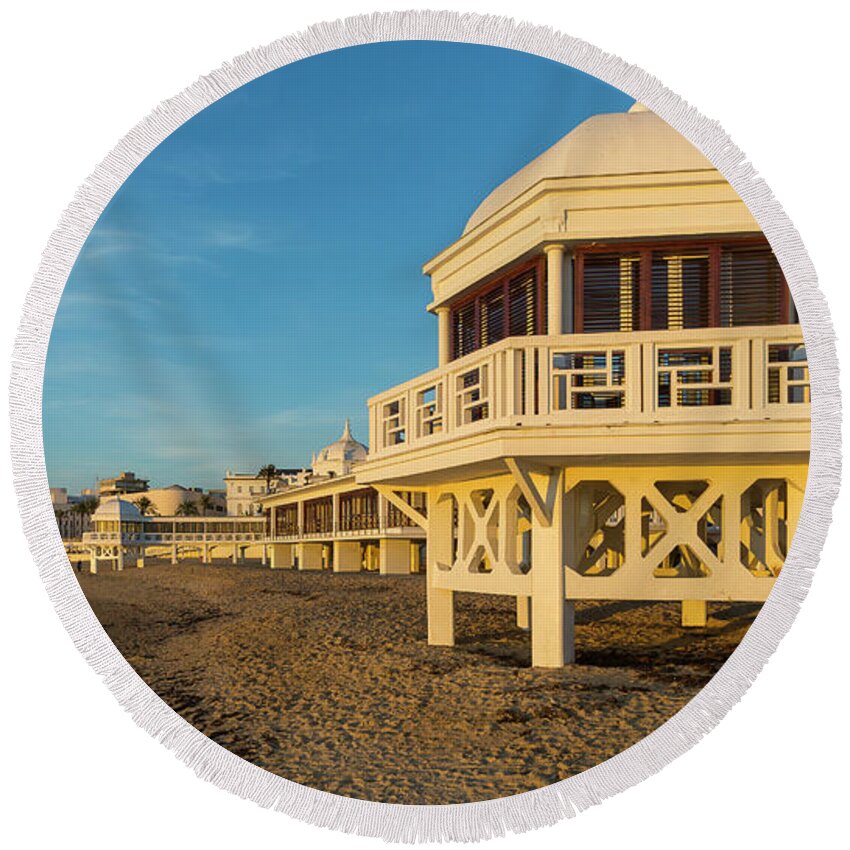 Seascape Round Beach Towel featuring the photograph Spa at La Caleta under a Blue Sky Beach in Cadiz Andalusia by Pablo Avanzini