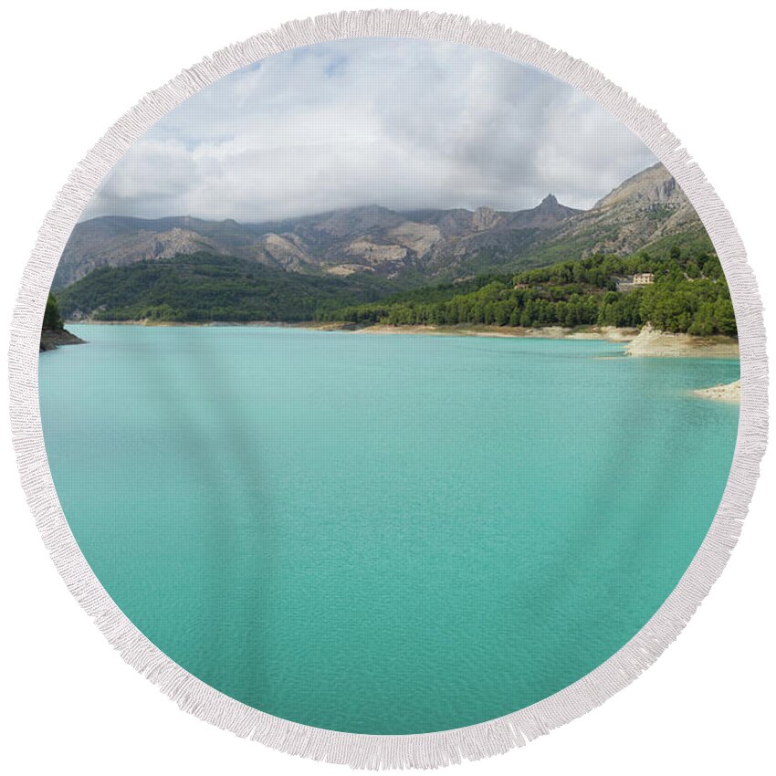 Guadalest Round Beach Towel featuring the photograph Turquoise blue water and mountain landscape by Adriana Mueller