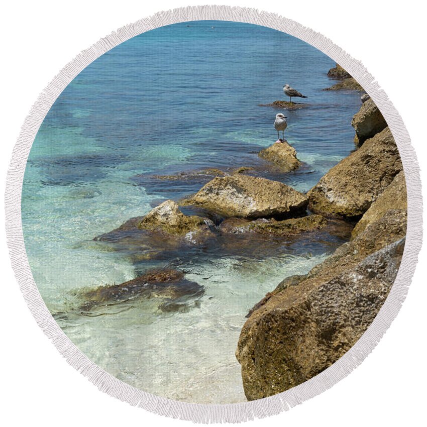 Mediterranean Round Beach Towel featuring the photograph Turquoise blue sea water and rocks in Calpe 2 by Adriana Mueller