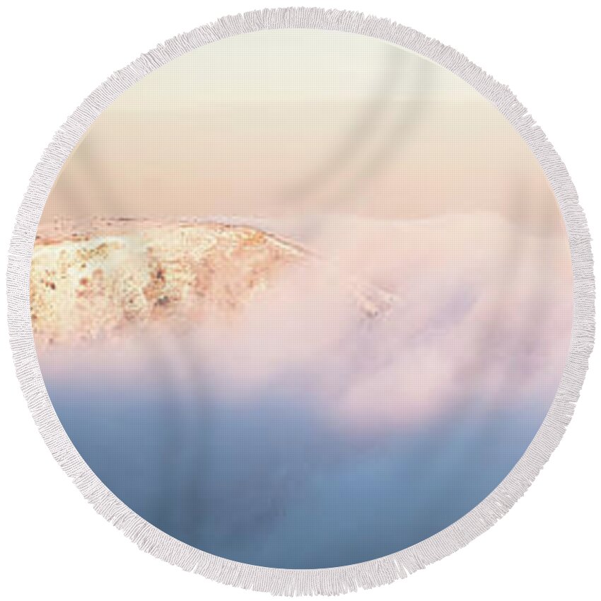 Abstract Round Beach Towel featuring the photograph Two peaks emerge from purple clouds at sunset by Jean-Luc Farges
