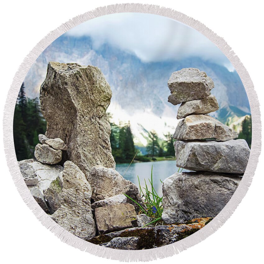 Two Round Beach Towel featuring the photograph Two stone towers as route markers. by Bernhard Schaffer