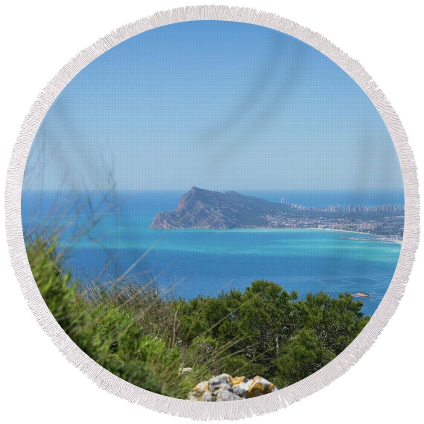 Spain Round Beach Towel featuring the photograph View of the coast and the Mediterranean sea in Benidorm by Adriana Mueller