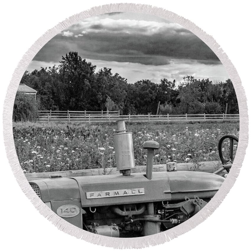 Farm Round Beach Towel featuring the photograph Vintage Farmall 140 in front of Wilflower field BW by Photographic Arts And Design Studio