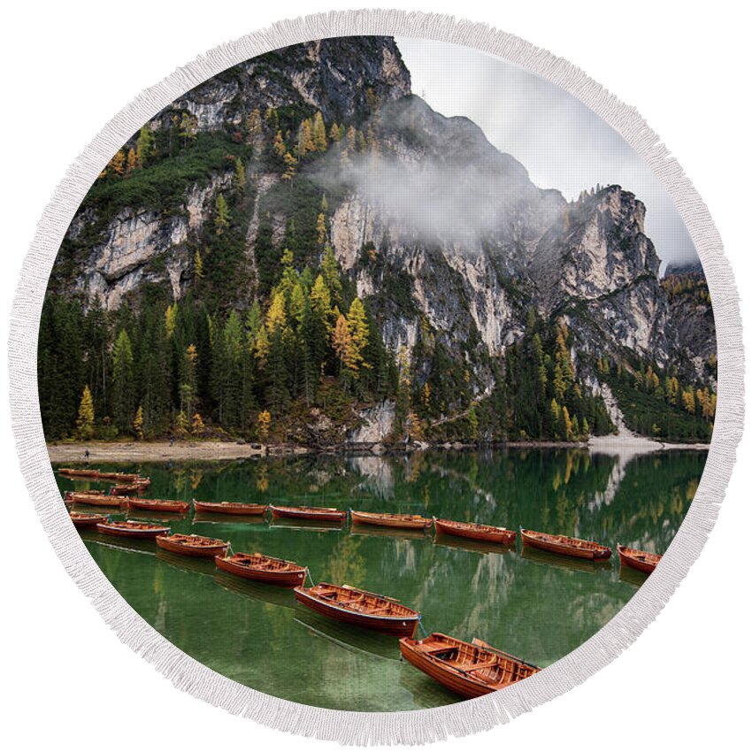 Lago Di Braies Round Beach Towel featuring the photograph Wooden boats on the peaceful lake. Lago di braies, Italy by Michalakis Ppalis