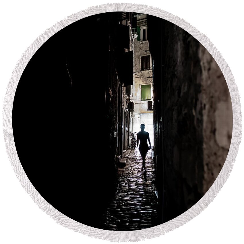  Round Beach Towel featuring the photograph Young Woman Walks Alone Through Spooky Narrow Abandoned Alley In The Night by Andreas Berthold