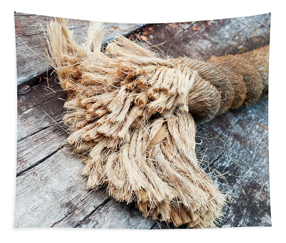 Frayed end of sisal rope lying on weathered wood Tapestry by