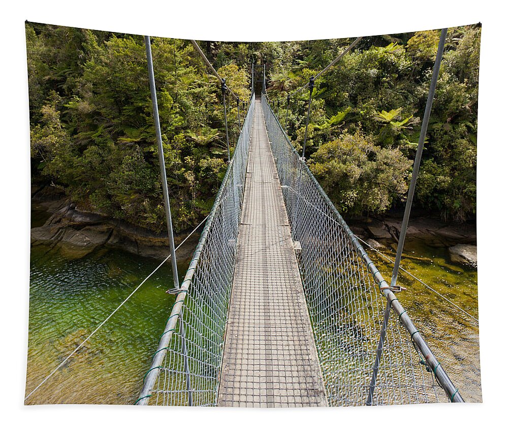 Adventure Tapestry featuring the photograph Swing bridge over green jungle river New Zealand by Stephan Pietzko