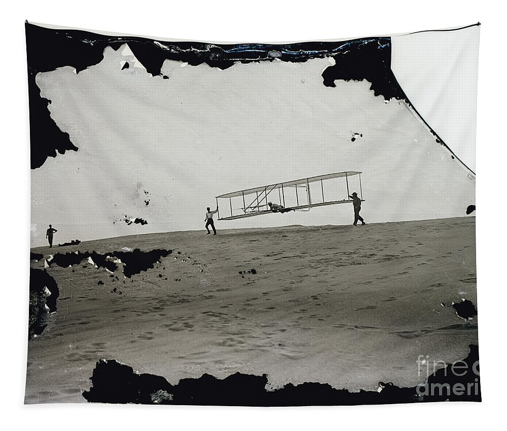 The Wright Brothers Tapestry featuring the photograph The Wright Brothers Wilbur in motion at left holding one end of glider by Vintage Collectables