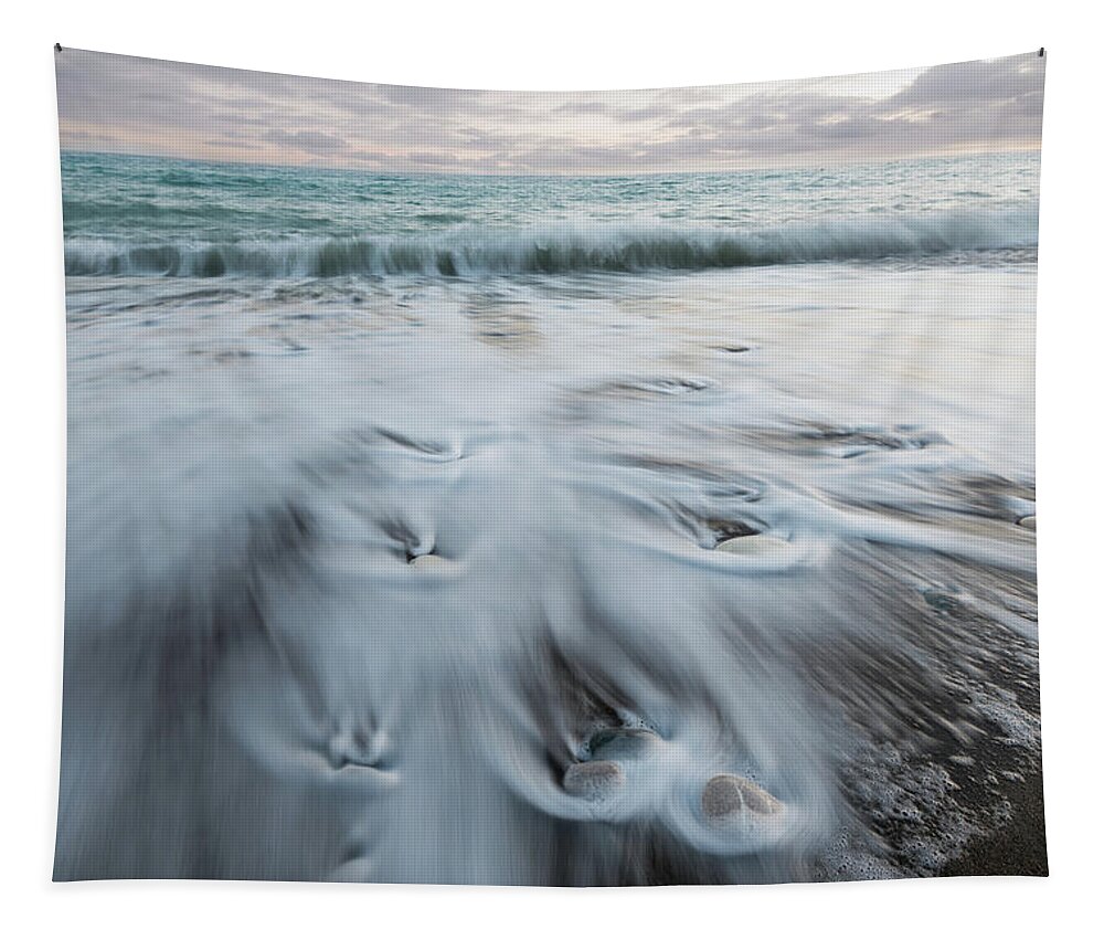 Coastline Tapestry featuring the photograph Pebbles in the beach and flowing sea water by Michalakis Ppalis