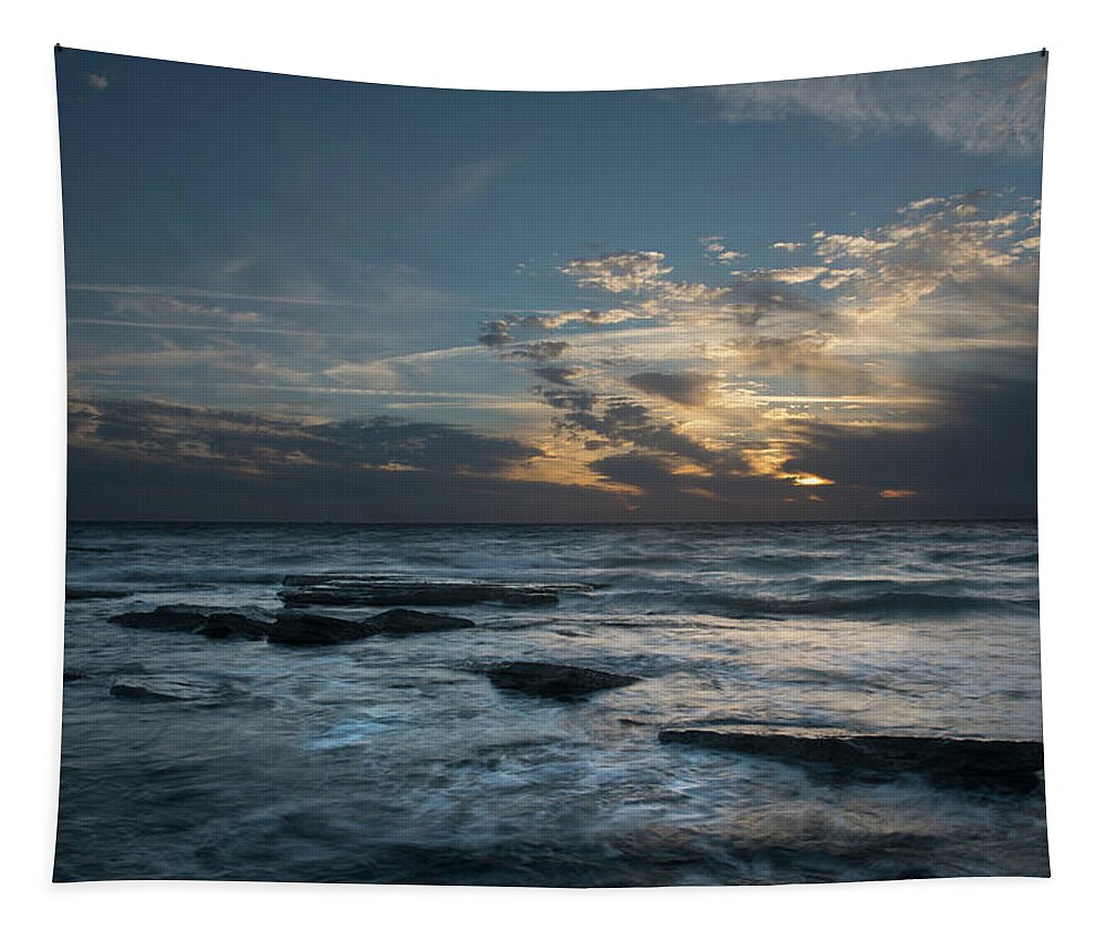 Sunset Over Sea Tapestry featuring the photograph Sunset on a rocky beach by Michalakis Ppalis