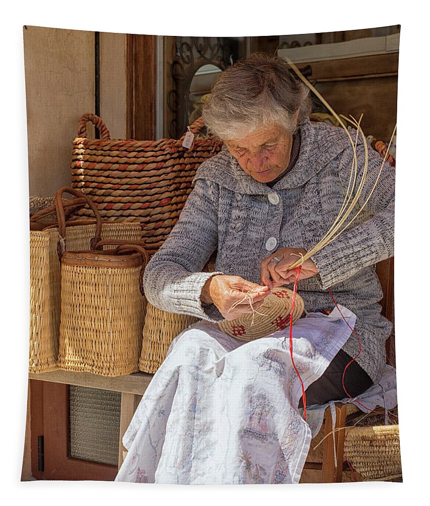 Adult Tapestry featuring the photograph A woman weaving a basket in Castelsardo by Patricia Hofmeester