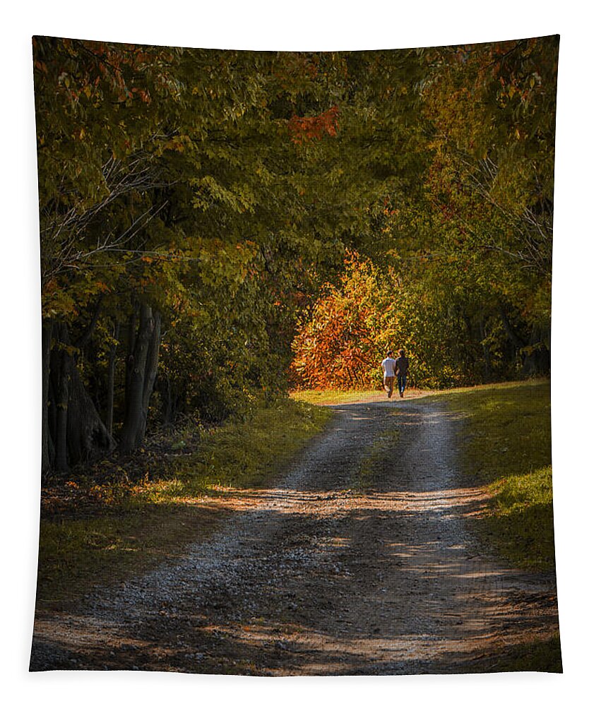 Art Tapestry featuring the photograph Couple walking on a Dirt Road through a Tree Canopy during Autumn by Randall Nyhof